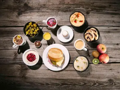 a table topped with plates of food and drinks at B&B Hotel Amsterdam-Zaandam in Zaandam