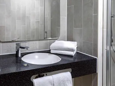 a bathroom with a sink and a mirror at B&B Hotel Amsterdam-Zaandam in Zaandam