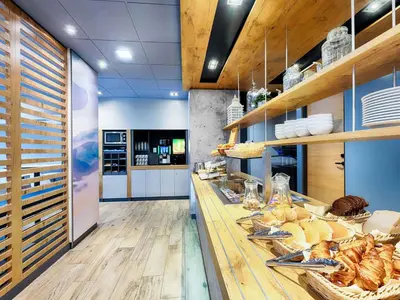a bakery with a counter with bread and pastries at B&B Hotel Amsterdam-Zaandam in Zaandam