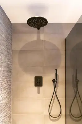 a shower stall with a shower head and a shower at Studio 23 in Zandvoort