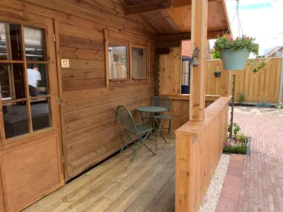 a wooden cabin with a table and chairs on a deck at B&B Diemerplein in Amsterdam