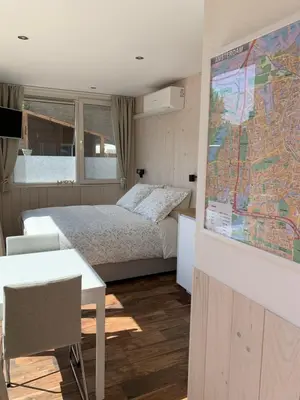 a hotel room with a bed and a map on the wall at B&B Diemerplein in Amsterdam