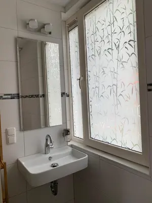 a bathroom with a sink and a window at B&B Diemerplein in Amsterdam