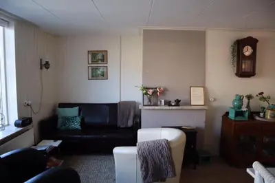 a living room with a couch and a fireplace at Bijzonder Bakkum in Castricum