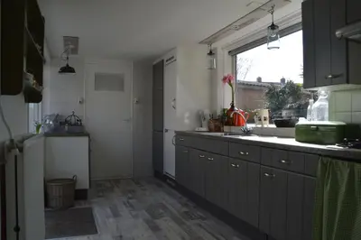a kitchen with a sink and a counter top at Bijzonder Bakkum in Castricum