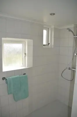 a bathroom with a shower and a blue towel at Bijzonder Bakkum in Castricum