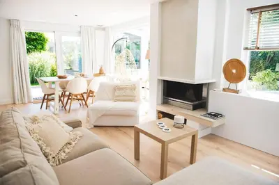 a living room with a couch and a table at Luxury villa on peaceful location. Boat optional in Vinkeveen