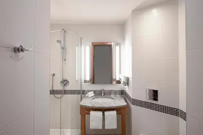 a bathroom with a sink and a shower at Hampton by Hilton Amsterdam Airport Schiphol in Hoofddorp