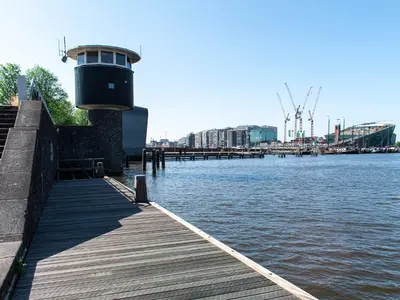 a wooden dock next to a body of water at SWEETS - Kortjewantsbrug in Amsterdam