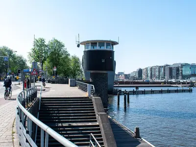 a boat is docked next to the water at SWEETS - Kortjewantsbrug in Amsterdam