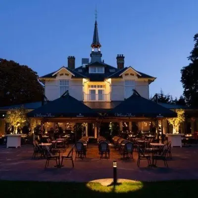 a restaurant with tables and chairs in front of a building at Boutiquerooms WesterVilla Amsterdam in Amsterdam