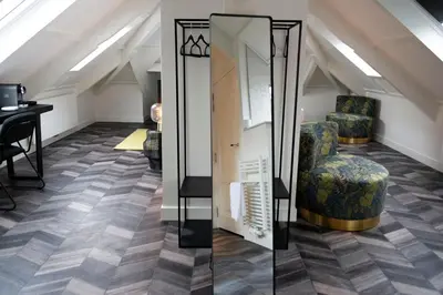 a room with two chairs and a mirror at Boutiquerooms WesterVilla Amsterdam in Amsterdam