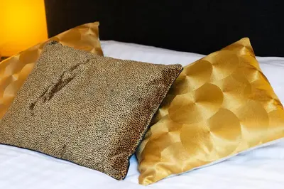 two pillows sitting on top of a bed at Boutiquerooms WesterVilla Amsterdam in Amsterdam