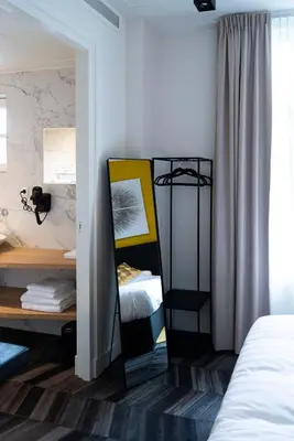 a bedroom with a mirror next to a bed at Boutiquerooms WesterVilla Amsterdam in Amsterdam