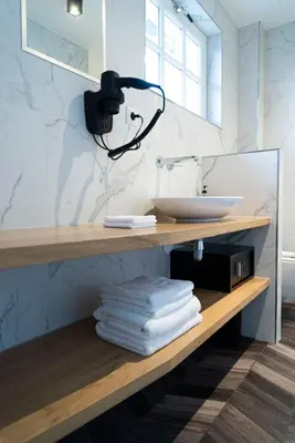 a bathroom with a counter with a sink and a mirror at Boutiquerooms WesterVilla Amsterdam in Amsterdam