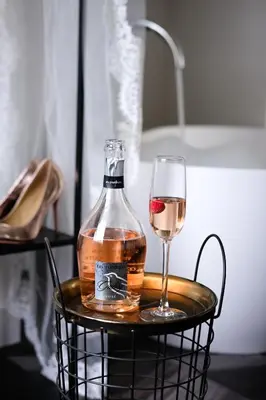 a bottle of wine and a glass on a basket at Boutiquerooms WesterVilla Amsterdam in Amsterdam