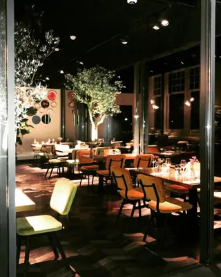 a restaurant with tables and chairs in a room at Boutiquerooms WesterVilla Amsterdam in Amsterdam