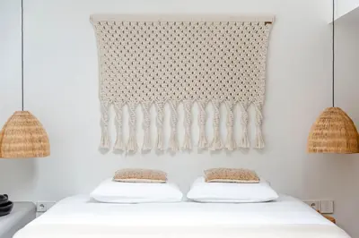 a bedroom with a white bed with two pillows at Suite-Suite luxury private guesthouse in Zandvoort