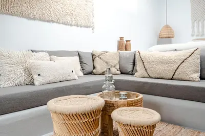 a living room with a couch with pillows at Suite-Suite luxury private guesthouse in Zandvoort