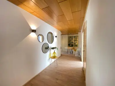 a hallway with white walls and a wooden ceiling at Apartment Kerkplein 7A in Zandvoort