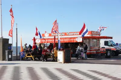 a food truck with people sitting outside of it at Apartment Kerkplein 7A in Zandvoort