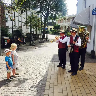 a group of men playing music and a little child at Apartment Kerkplein 7A in Zandvoort