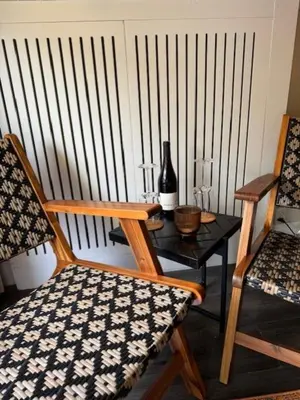 a chair and a table with a bottle of wine at Toast by night in Haarlem