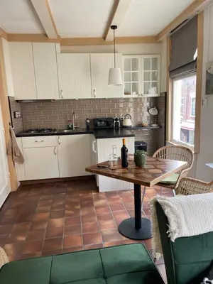 a kitchen with a table in the middle of a room at Toast by night in Haarlem