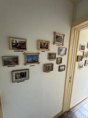 a wall with framed pictures on a wall at Toast by night in Haarlem