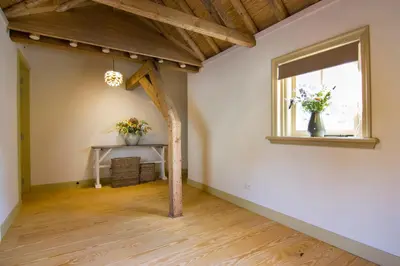 an empty room with a table and a window at Gasterij Leyduin in Vogelenzang