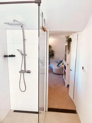 a bathroom with a shower with a glass door at Zandvoort Paradise Boutique Chambre in Zandvoort