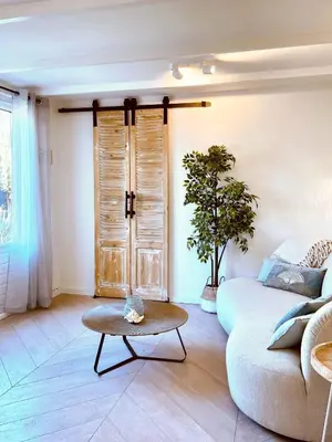 a living room with a couch and a table at Zandvoort Paradise Boutique Chambre in Zandvoort