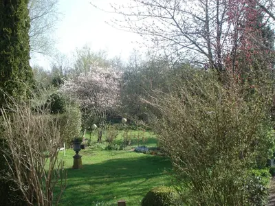 a garden with a birdbath in the middle of the grass at Aan de Vecht in Nederhorst den Berg