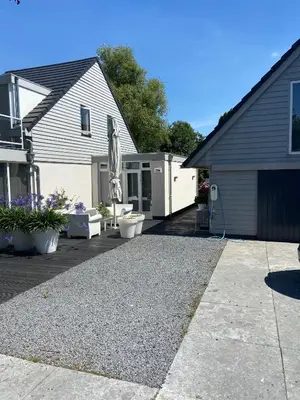a house with a gravel driveway in front of it at Aan de Vecht in Nederhorst den Berg