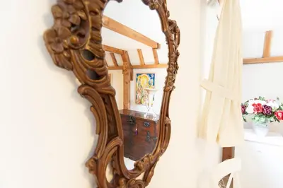 a mirror hanging on a wall in a room at Bed & Breakfast of Art in Amsterdam