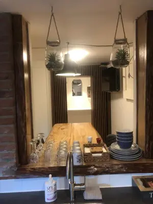a kitchen counter with a sink and a mirror at B&B CaSandra in Volendam