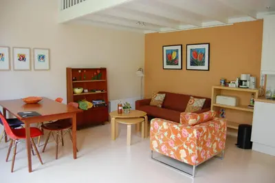 a living room with a couch and a table at Lelymare Logies in Lelystad