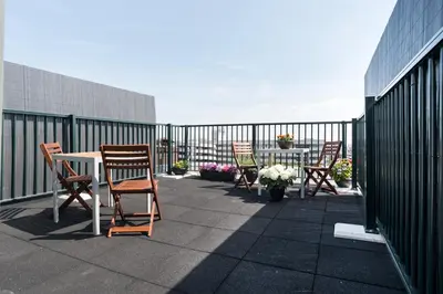 a patio with chairs and a table on a balcony at Central Rooftop Terrace Guest Suite in Amsterdam