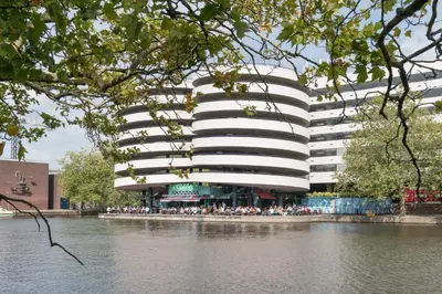 a building with a bunch of people sitting in front of it at Central Rooftop Terrace Guest Suite in Amsterdam