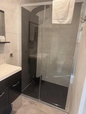 a shower with a glass door in a bathroom at Carpe Diem in Zandvoort