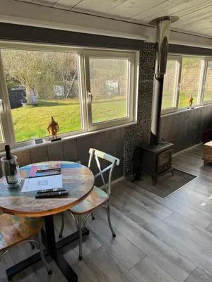 a room with a table and a wood stove at Carpe Diem in Zandvoort