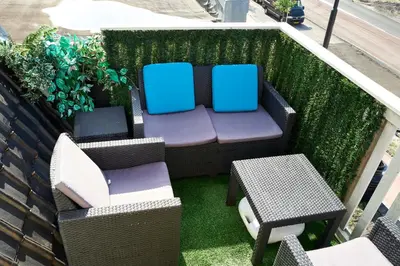a balcony with two chairs and a table at Sleep Inn Amsterdam in Amsterdam