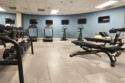 a gym with several tread machines in a room at Room Mate Aitana, Amsterdam in Amsterdam