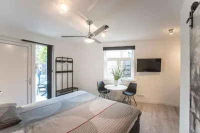 a bedroom with a bed and a table with chairs at Amsterdam Beach Zandvoort Studio s in Zandvoort