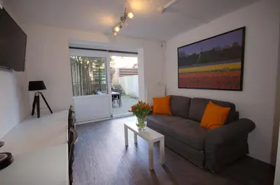a living room with a couch and a table at Pension Oranje in Zandvoort