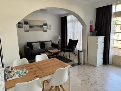 a living room with a table and a couch at Appartement Villa Eva Rosa in Wijk aan Zee
