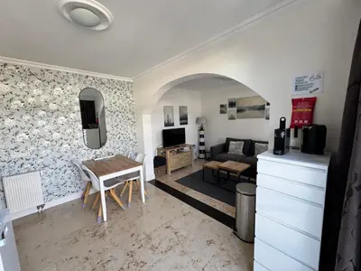 a living room with a table and a couch at Appartement Villa Eva Rosa in Wijk aan Zee
