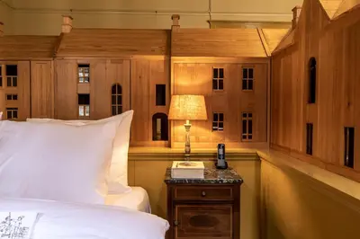 a bedroom with a bed and a lamp on a table at Hotel Beijers in Utrecht
