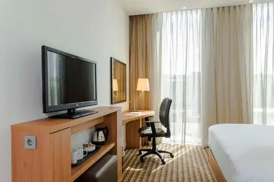 a hotel room with a bed and a television at Hampton By Hilton Amsterdam Arena Boulevard in Amsterdam
