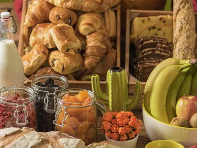 a table with a bunch of bread and other foods at ibis Styles Almere in Almere